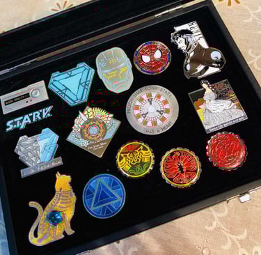 a black case with a variety of pins and badges