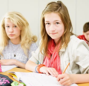 3 children at a desk working