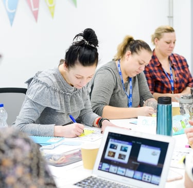 3 ladies taking notes at a desk