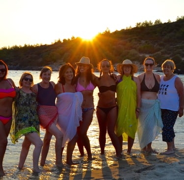 A group of women in swimwear, standing in the sea in Turkey in the afternoon sun