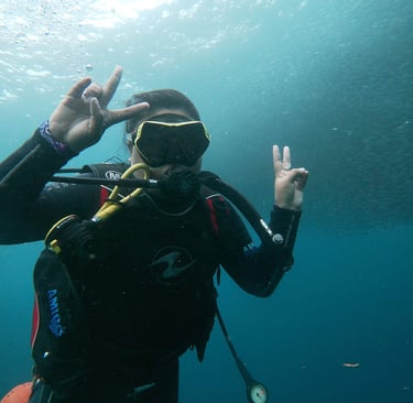 Girl in a scuba suit and scuba goggles in the water