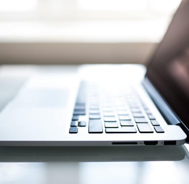 a laptop computer sitting on a table with a laptop