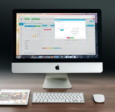 a computer monitor and a keyboard on a desk