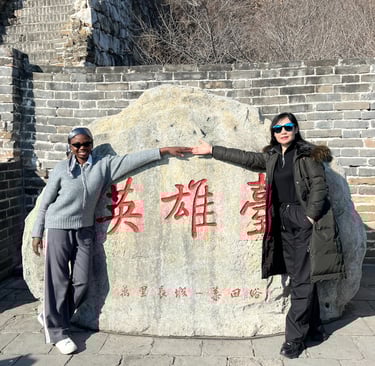 Two people holding hands at the great wall of China. Travelling for sports tourism