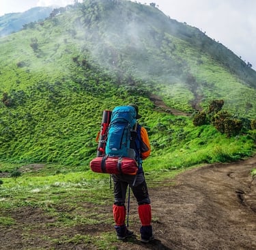 a man with a backpack on a mountain