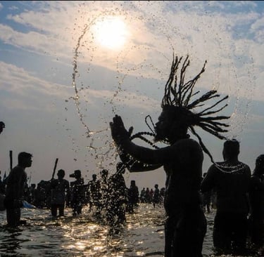 a man with dreadlocks and dreadlocks standing in the water