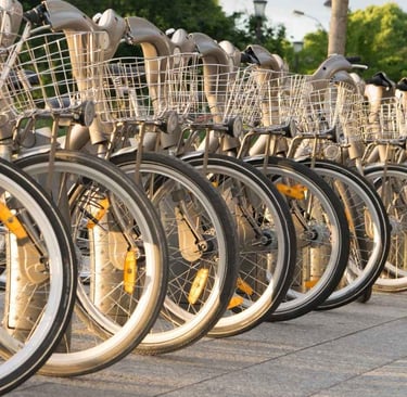 Bicycle rental station in Paris with rows of grey bikes lined up for visitors