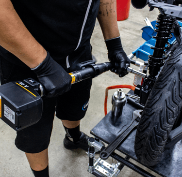a man in black gloves and gloves is holding a bike