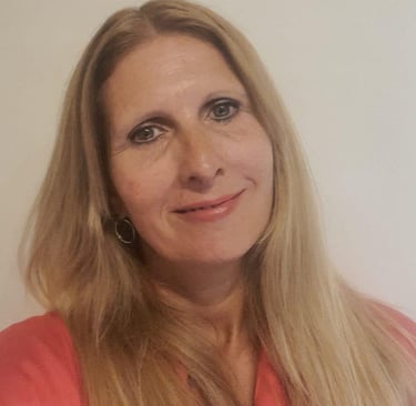 a woman with blonde hair and a pink shirt