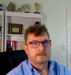 a man in a blue shirt and glasses