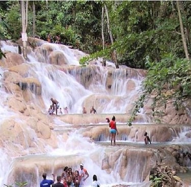 Dunn’s River Falls waterfall in Ocho Rios, Jamaica surrounded by lush tropical scenery