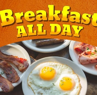 Breakfast all day menu with sunny side up eggs, crispy bacon, sausage, and ham on white plates.