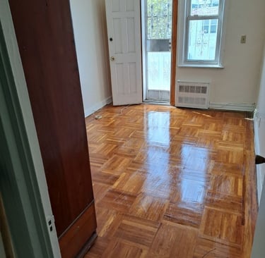 Sunlit bedroom leading to back porch.