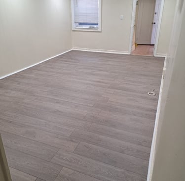 Renovated living room with new floors and recessed lights.