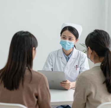 A group of allied health workers collaborating in a bright, modern healthcare facility.