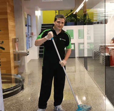Clean Planet Wellington staff member mopping commercial office floor in Wellington