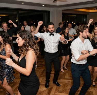 Crowd raising hands and dancing joyfully at a corporate event with dynamic lighting effects.