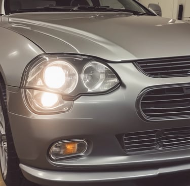 View of the Otouygulamamerkezi workshop where car software programming is being done with partner logos visible.