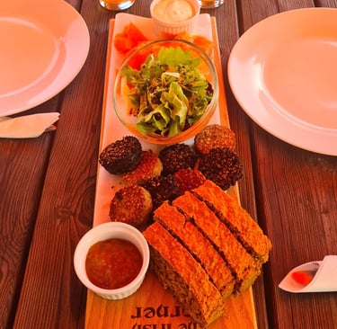 Traditional Irish food platter with soda bread, black pudding, salmon, and salad on a wooden board.