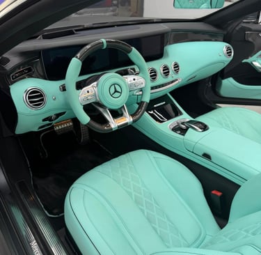 Custom Mercedes-Benz interior featuring Tiffany blue leather seats and matching mint dashboard accents.