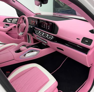 Custom pink and white leather interior of a luxury Mercedes-Benz SUV dashboard and seats.