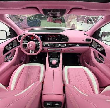 Custom pink leather Mercedes interior with matching steering wheel and dashboard.