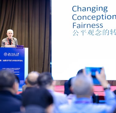 Randy Bennett at podium with slide titled "Changing Conceptions of Fairness" shown in English and Chinese