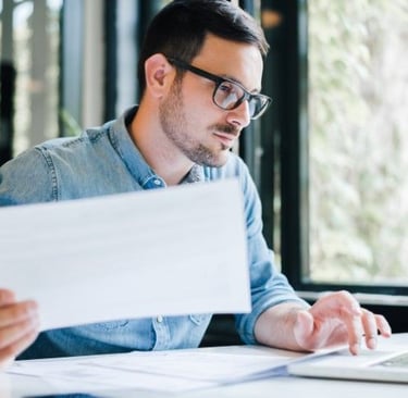 Bookkeeper reviewing financial statements on a laptop