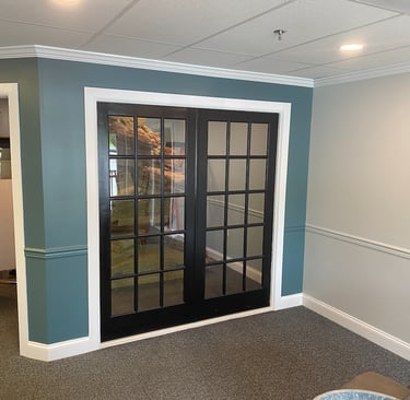a living room with a couch and a television and a fresh paint job