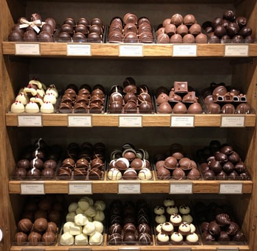 A beautifully arranged gift box filled with assorted chocolates and nougats.