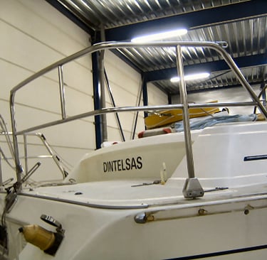 a boat in a warehouse with a metal railing