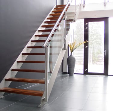 a staircase with a metal and glass railing