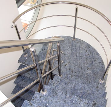a spiral staircase with a metal railing