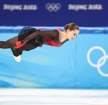 Kamila Valieva performs a high jump during a figure skating program at the Beijing 2022 Winter Olympics.
