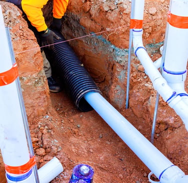 Stormwater pipe system installation with connected drainage pipes in residential ground