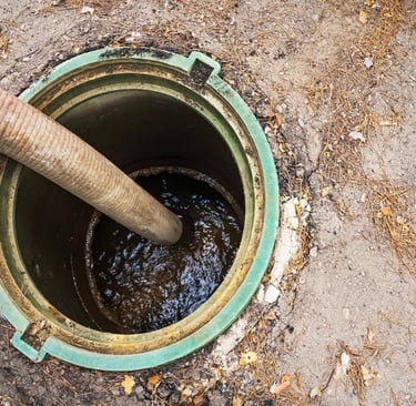 High-pressure drain jetting clearing blocked pipe and removing debris buildup