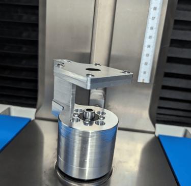 Aluminium metrology fixture for holding shaft component on optical shaft scanner. 