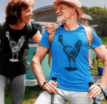 Smiling senior couple wearing rooster graphic trendyt-shirts while hiking near a vintage camper van.