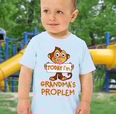 Toddler wearing a funny monkey trendy t-shirt that says Grandma's Problem at a playground.