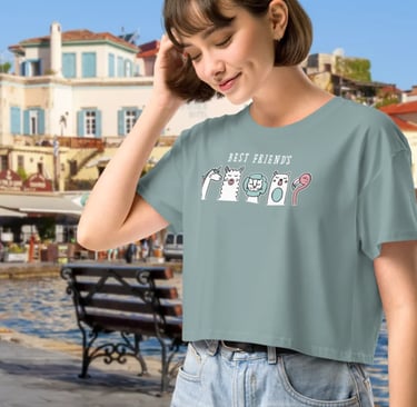 Woman wearing a Best Friends graphic crop top t-shirt by a sunny European harbor.