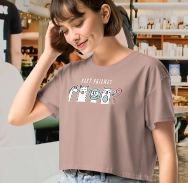 Woman wearing a dusty rose crop top t-shirt featuring a cute cartoon animal illustration.