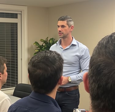 Adam Bair leading a strategic workshop for entrepreneurs, discussing business resilience and growth 