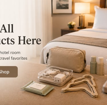 Travel essentials and hotel room accessories including toiletries and chargers on a bed.