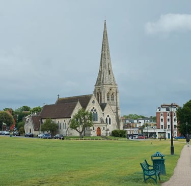 A scenic view of the historic St Mary's Church with its tall spire overlooking Blackheath Common in London.