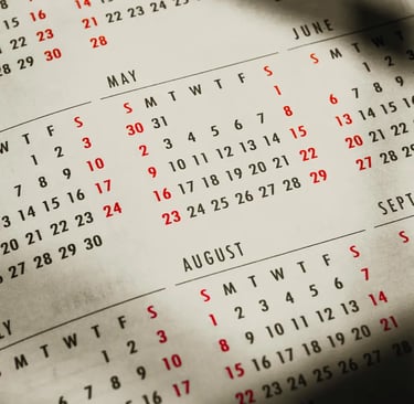A close-up of an open paper calendar showing multiple months, ideal for planning, scheduling, and date tracking.