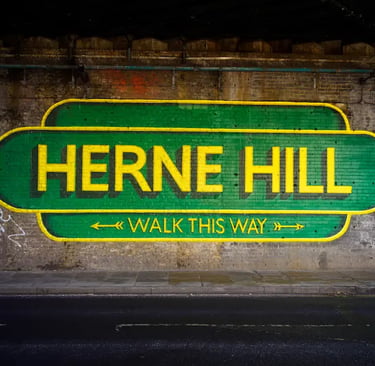 Herne Hill Walk This Way street art mural painted on a brick wall under a railway bridge.