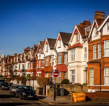 Row of traditional red brick Victorian terraced houses on a quiet suburban street in Streatham.