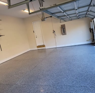 a garage with a garage door open and a garage door open