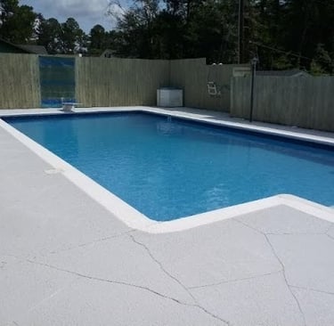 a pool with a fenced in area with a fenced in area