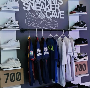 A stylish sneaker display with various shoe styles and sports jerseys in Giovanni's sneaker cave.